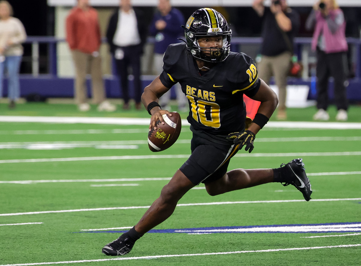 Terry Bussey rolls out of the pocket during Timpson's 49-7 win over Tolar in the 2A Division I state title at AT&T Stadium.